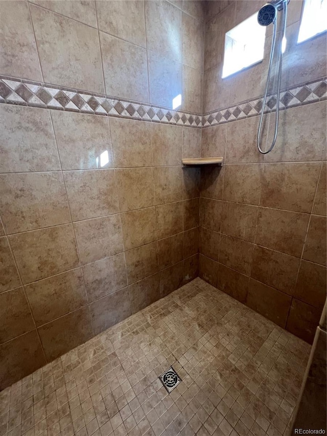 bathroom with a tile shower