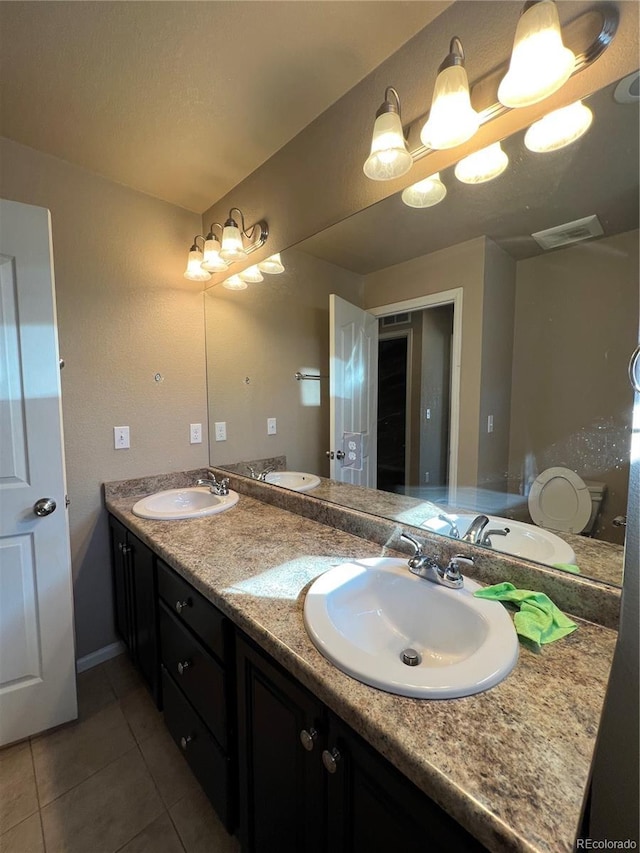 bathroom featuring tile patterned floors, vanity, and toilet