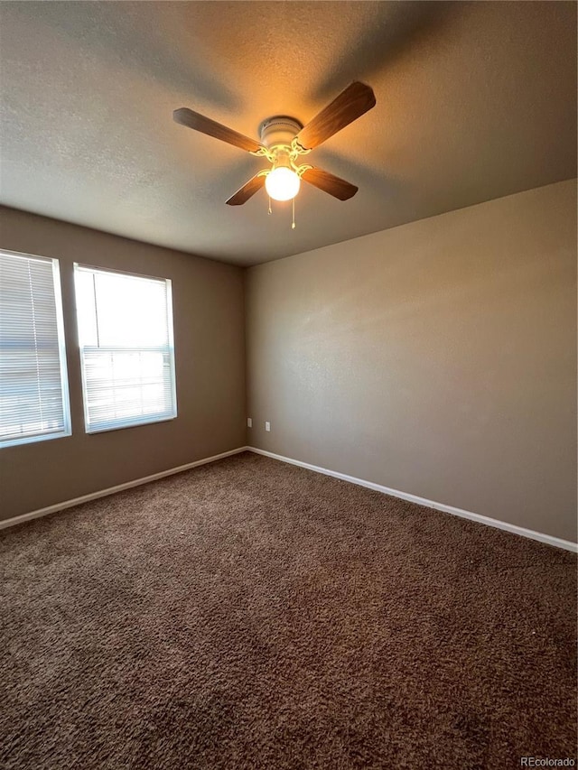 carpeted empty room featuring ceiling fan and a textured ceiling