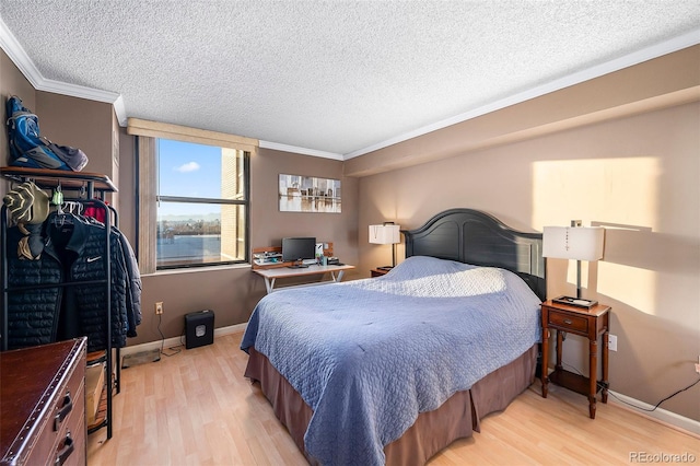 bedroom with a textured ceiling, crown molding, and light wood-type flooring