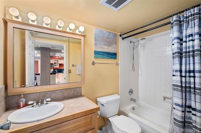 full bathroom featuring vanity, toilet, visible vents, and shower / tub combo with curtain