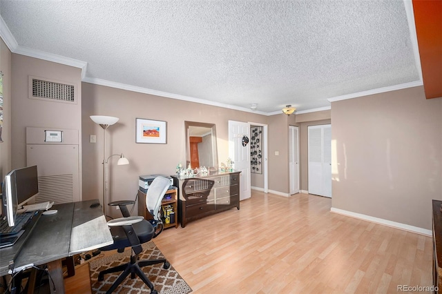 office space with light wood-type flooring, ornamental molding, and a textured ceiling