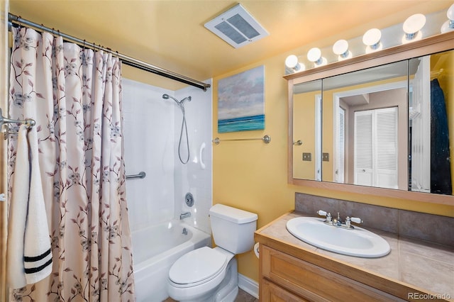 bathroom with visible vents, toilet, vanity, and shower / tub combo