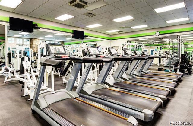 gym with a paneled ceiling and visible vents