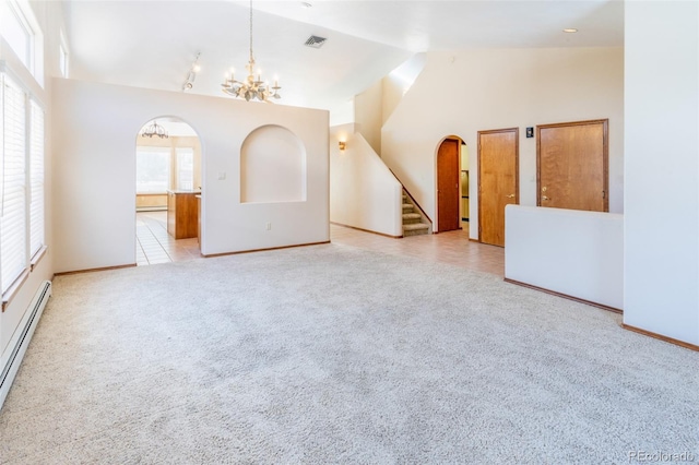 carpeted empty room featuring a baseboard radiator, an inviting chandelier, and high vaulted ceiling