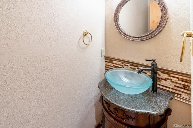 bathroom featuring backsplash and vanity