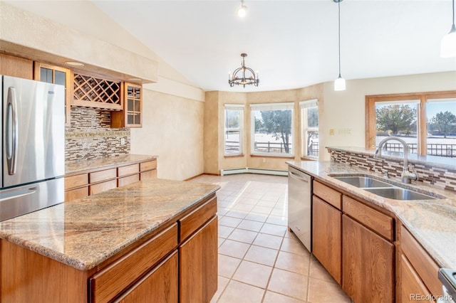 kitchen featuring decorative light fixtures, stainless steel appliances, decorative backsplash, sink, and light tile patterned flooring