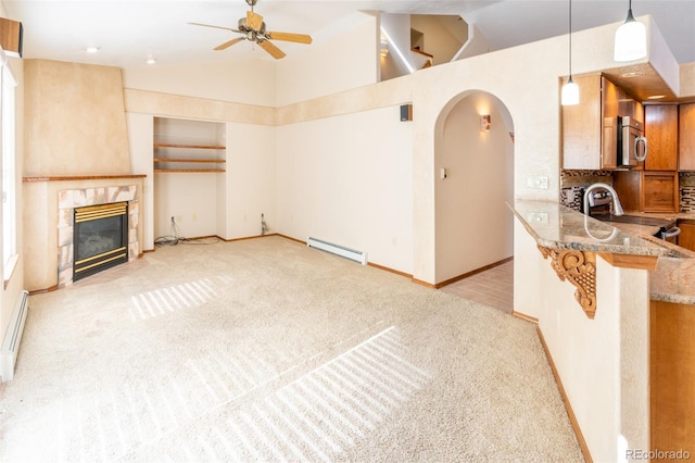 carpeted living room featuring ceiling fan, high vaulted ceiling, baseboard heating, and a fireplace