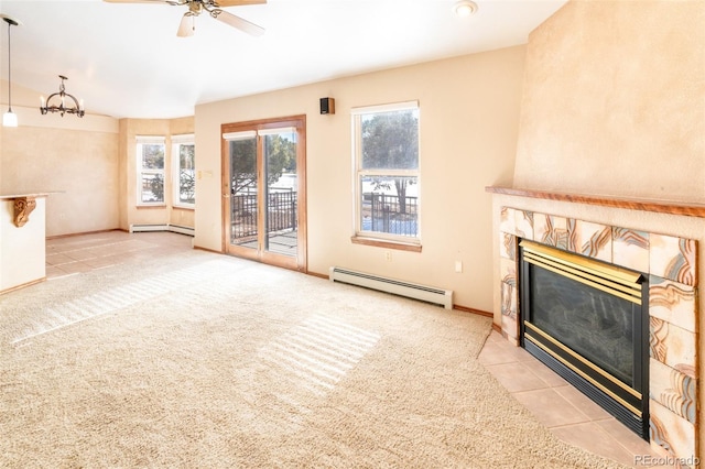 unfurnished living room featuring light carpet, a tiled fireplace, ceiling fan, and a baseboard heating unit