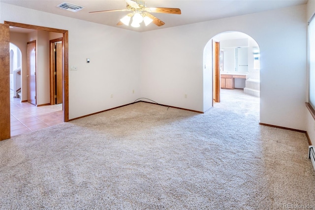 carpeted empty room featuring a wealth of natural light and ceiling fan