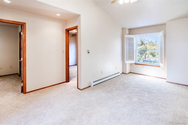 unfurnished room with ceiling fan, light colored carpet, and a baseboard heating unit