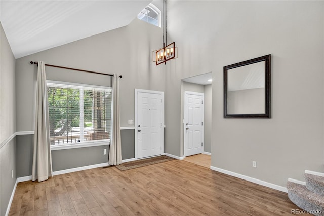 4535 Hunterwood Dr, Highlands Ranch, CO 80130 - entryway with healthy amount of natural light, high vaulted ceiling, a chandelier, wood finished floors, and stairway