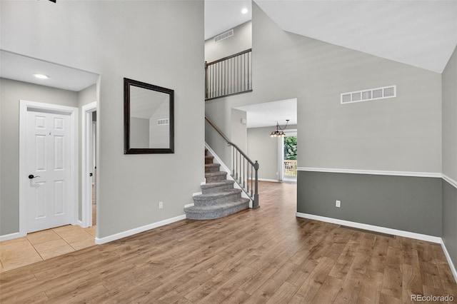 4535 Hunterwood Dr, Highlands Ranch, CO 80130 - foyer entrance featuring a high ceiling, wood finished floors, stairs, a chandelier, and recessed lighting