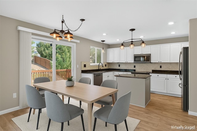 4535 Hunterwood Dr, Highlands Ranch, CO 80130 - dining area featuring healthy amount of natural light, a chandelier, light wood finished floors, and recessed lighting