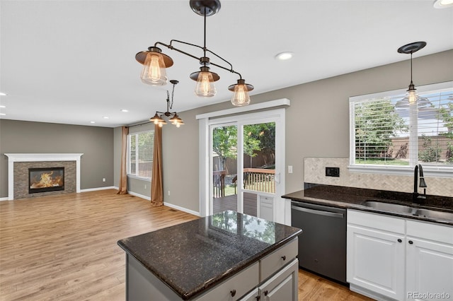 4535 Hunterwood Dr, Highlands Ranch, CO 80130 - kitchen featuring stainless steel dishwasher, light wood-style floors, pendant lighting, tasteful backsplash, and recessed lighting