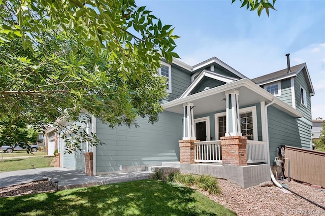 4535 Hunterwood Dr, Highlands Ranch, CO 80130 - view of front of home featuring a porch, concrete driveway, and a front yard