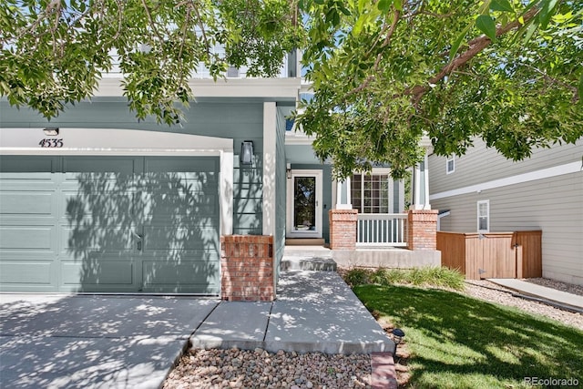 4535 Hunterwood Dr, Highlands Ranch, CO 80130 - view of front of property with driveway, an attached garage, covered porch, and brick siding
