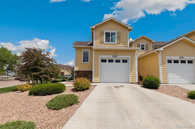 5302 Canadian Rose Vw, Colorado Springs, CO 80916 - traditional-style house featuring driveway, an attached garage, and stone siding