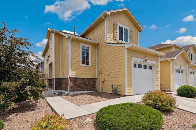 5302 Canadian Rose Vw, Colorado Springs, CO 80916 - view of property exterior featuring stone siding and an attached garage