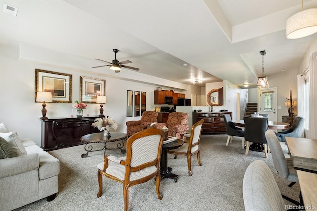 5302 Canadian Rose Vw, Colorado Springs, CO 80916 - living room featuring stairway, ceiling fan, and light colored carpet