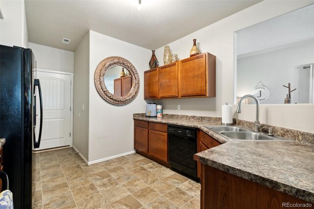5302 Canadian Rose Vw, Colorado Springs, CO 80916 - kitchen featuring black appliances, a sink, brown cabinets, baseboards, and stone finish floors