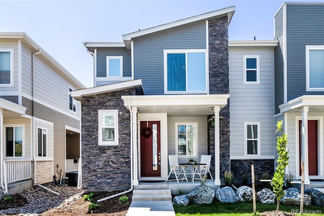 view of front of house with covered porch and stone siding