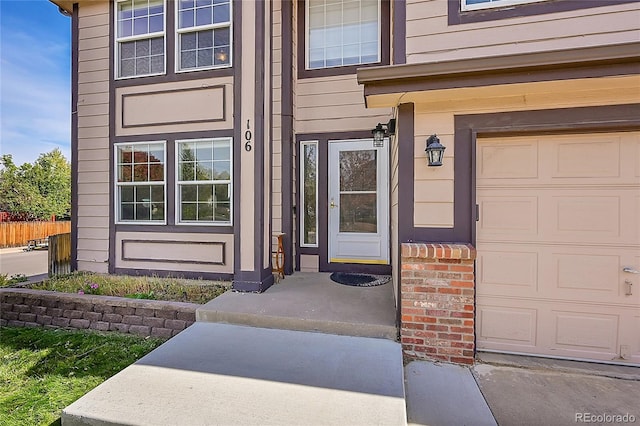 doorway to property with a garage