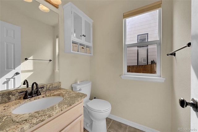 bathroom with vanity, tile patterned flooring, and toilet