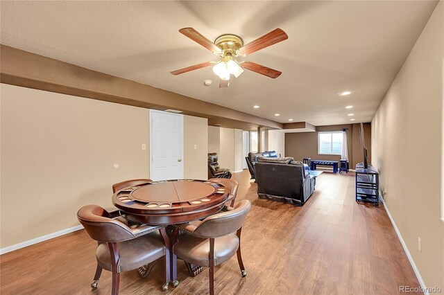 dining area with ceiling fan and light hardwood / wood-style floors