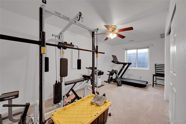 exercise area featuring light colored carpet and ceiling fan