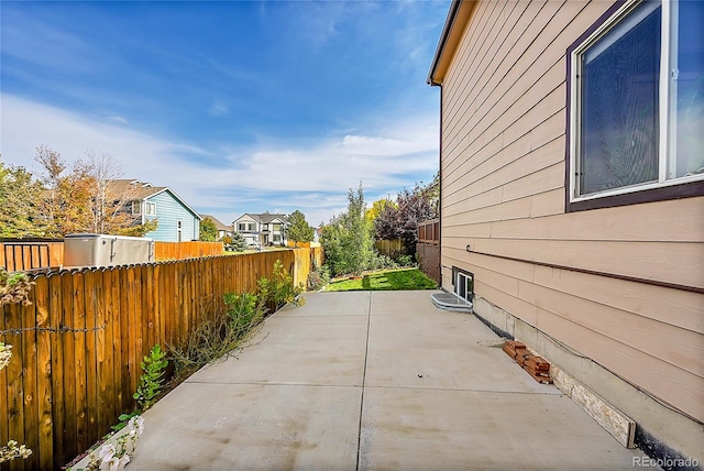 view of side of home with a patio area