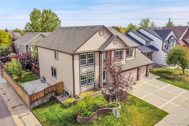 view of front of home with a garage and a front lawn