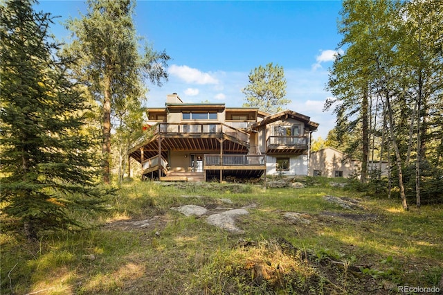 32217 Buffalo Park Rd, Evergreen, CO 80439 - back of house with a deck and a chimney