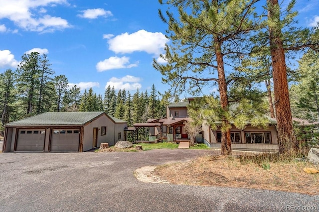 32217 Buffalo Park Rd, Evergreen, CO 80439 - view of front of property featuring an outdoor structure, a garage, and stucco siding