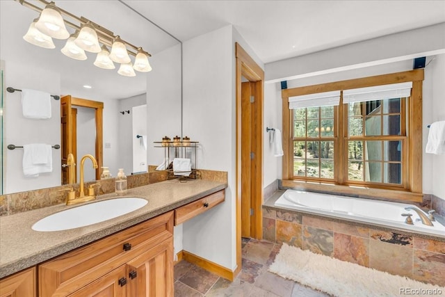 32217 Buffalo Park Rd, Evergreen, CO 80439 - bathroom featuring vanity, a garden tub, stone tile floors, and baseboards
