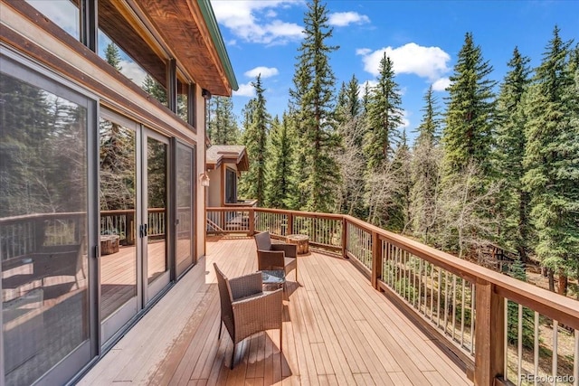 32217 Buffalo Park Rd, Evergreen, CO 80439 - wooden terrace featuring a forest view