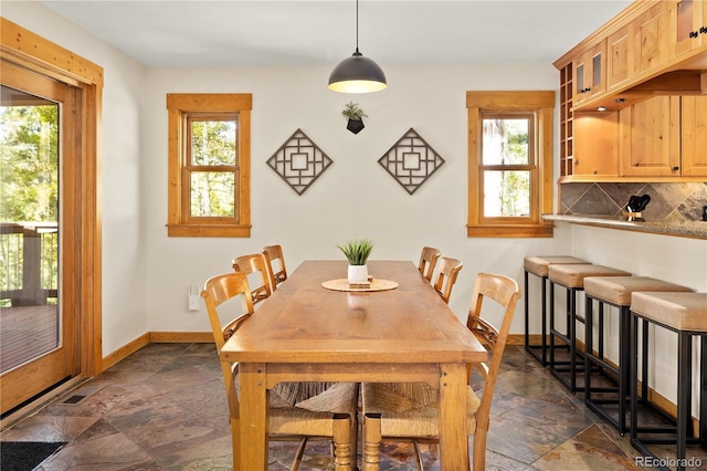 32217 Buffalo Park Rd, Evergreen, CO 80439 - dining area with stone tile floors, healthy amount of natural light, and baseboards