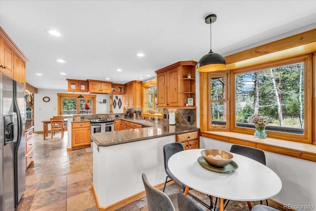 32217 Buffalo Park Rd, Evergreen, CO 80439 - kitchen with fridge with ice dispenser, a peninsula, electric range, plenty of natural light, and recessed lighting