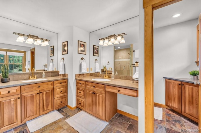 32217 Buffalo Park Rd, Evergreen, CO 80439 - full bath featuring a shower stall, baseboards, two vanities, and stone finish flooring