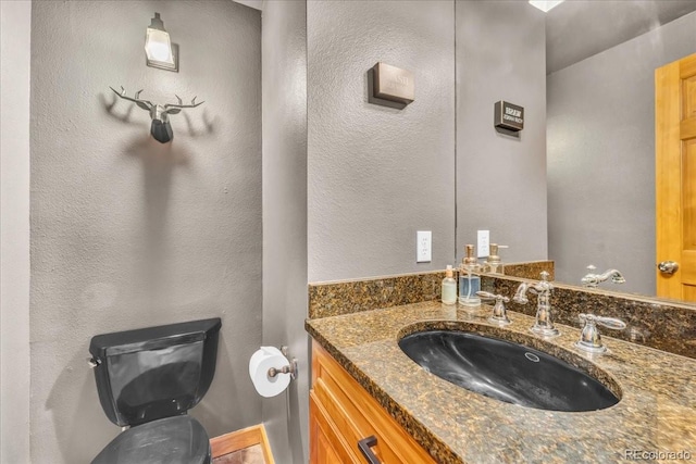 32217 Buffalo Park Rd, Evergreen, CO 80439 - bathroom with toilet, vanity, and a textured wall