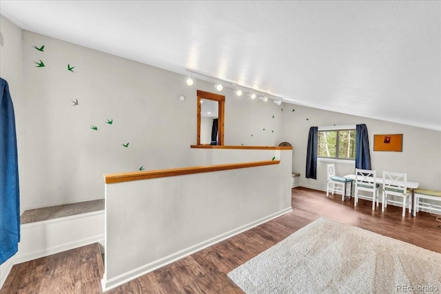 32217 Buffalo Park Rd, Evergreen, CO 80439 - bar with rail lighting, wood finished floors, lofted ceiling, and baseboards