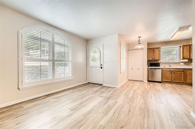 1648 S Cole St Unit A2, Lakewood, CO 80228 - entryway with a textured ceiling, light wood-type flooring, and baseboards