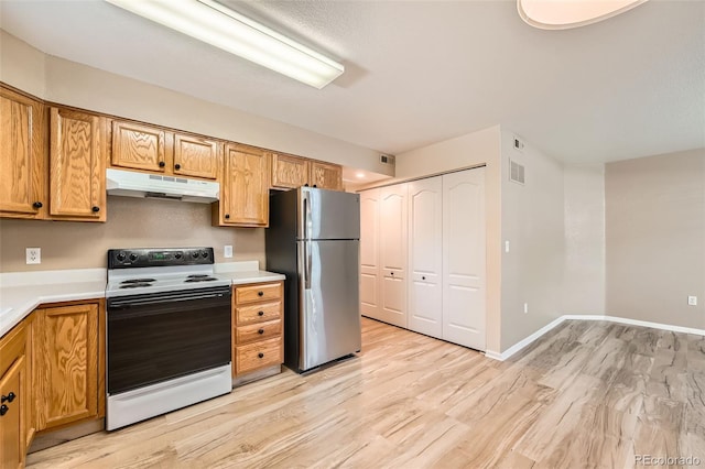 1648 S Cole St Unit A2, Lakewood, CO 80228 - kitchen featuring freestanding refrigerator, electric range oven, under cabinet range hood, light wood-style floors, and light countertops