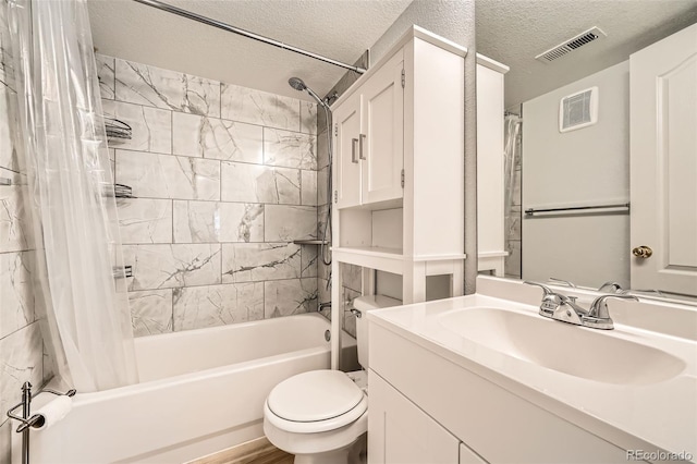 1648 S Cole St Unit A2, Lakewood, CO 80228 - bathroom featuring shower / bath combo, toilet, vanity, and a textured ceiling