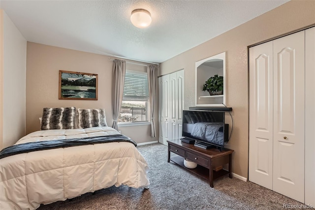 1648 S Cole St Unit A2, Lakewood, CO 80228 - carpeted bedroom featuring two closets, a textured ceiling, and baseboards