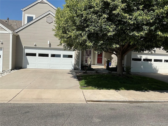 15555 E 40th Ave Unit 11, Denver, CO 80239 - view of property hidden behind natural elements with driveway and an attached garage