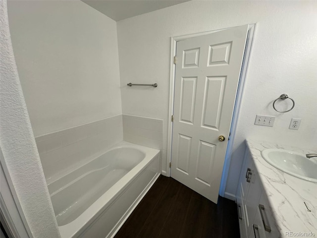 15555 E 40th Ave Unit 11, Denver, CO 80239 - full bathroom with wood finished floors, a bath, and vanity