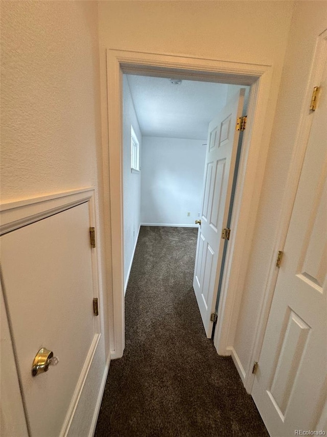 15555 E 40th Ave Unit 11, Denver, CO 80239 - hallway featuring dark colored carpet