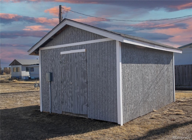 view of outbuilding with an outdoor structure and fence