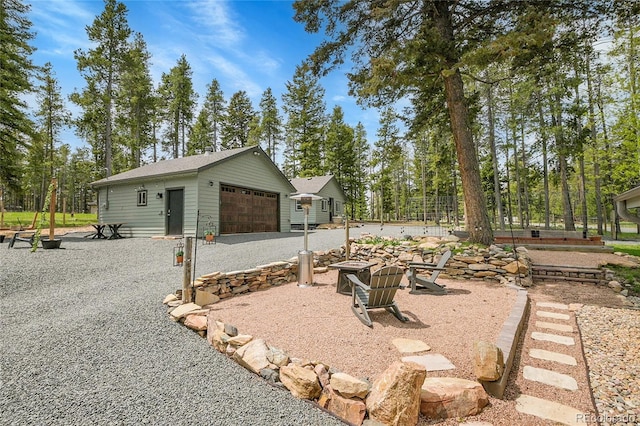 10887 Goodheart Ave, Conifer, CO 80433 - view of property exterior featuring a detached garage and an outdoor structure